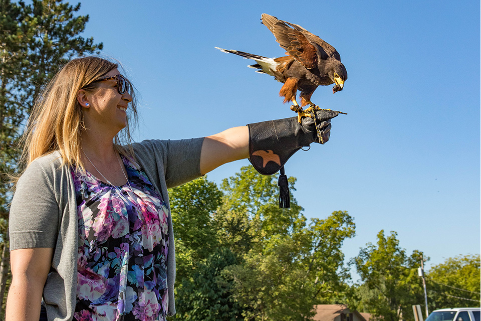 Woman holding bird at Ohio School of Falconry Woman holding bird at Ohio School of Falconry